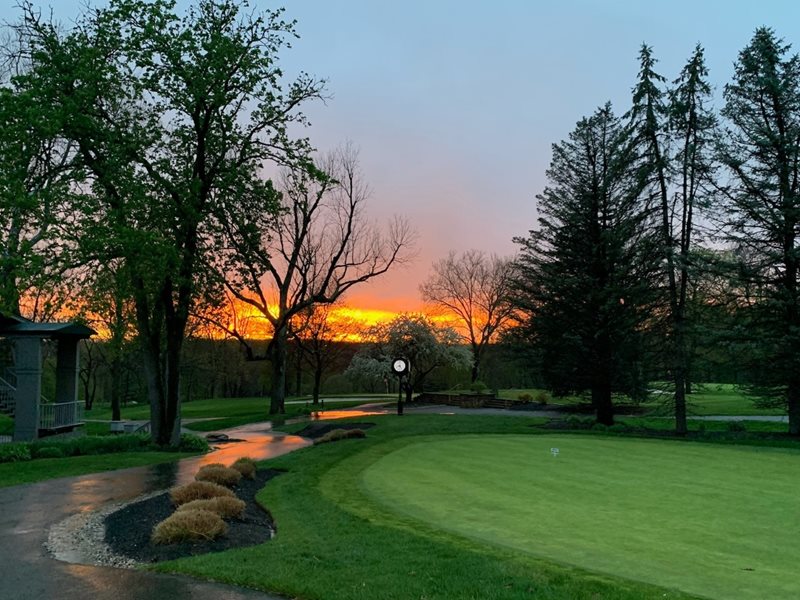 Sunset over the York Golf Club practice green and clock